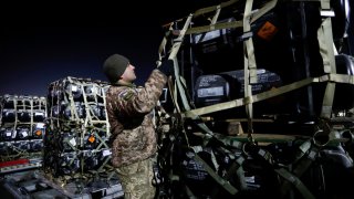 Ukrainian service members unpack Javelin anti-tank missiles, delivered by plane as part of the U.S. military support package for Ukraine, at the Boryspil International Airport outside Kyiv, Ukraine February 10, 2022.