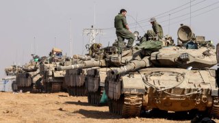 Israeli troops and tanks gather near the border with the Gaza Strip on December 3, 2023, after battles resumed between Israel and Hamas militants, as clashes continue between Israel and Hamas militants on December 3, 2023. 