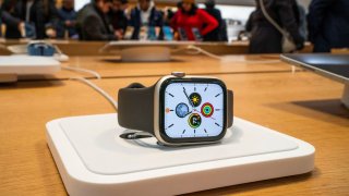 Apple smartwatches ads are displayed as customers take a look at smartwatch accessories at the Apple store in New York, U.S., December 26, 2023.Β