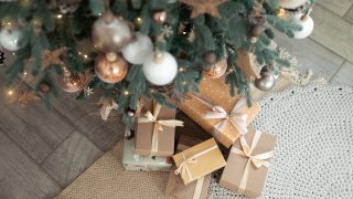 Close up of Christmas tree and presents in a beige aesthetic.