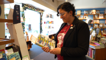 Amanda Qassar looks at a book in Warwick's bookstore in La Jolla on Dec. 15, 2023.