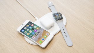 The Apple Inc. iPhone 8, Airpods, and Apple Watch sit on the AirPower charger during an event at the Steve Jobs Theater in Cupertino, California, U.S., on Tuesday, Sept. 12, 2017.