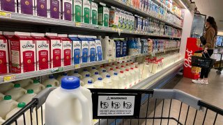 A customer shops for milk at a grocery store on December 12, 2023 in San Anselmo, California. 