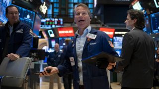 Traders work on the floor of the New York Stock Exchange (NYSE) during morning trading on January 3, 2024, in New York City.