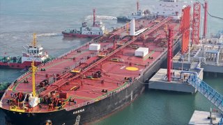 DONGYING, CHINA – NOVEMBER 15: An aerial view of tugboats push the crude oil tanker ‘VESNA’ from Singapore to a reception terminal of Dongying port on November 15, 2023 in Dongying, Shandong Province of China. (Photo by Zhou Guangxue/VCG via Getty Images)