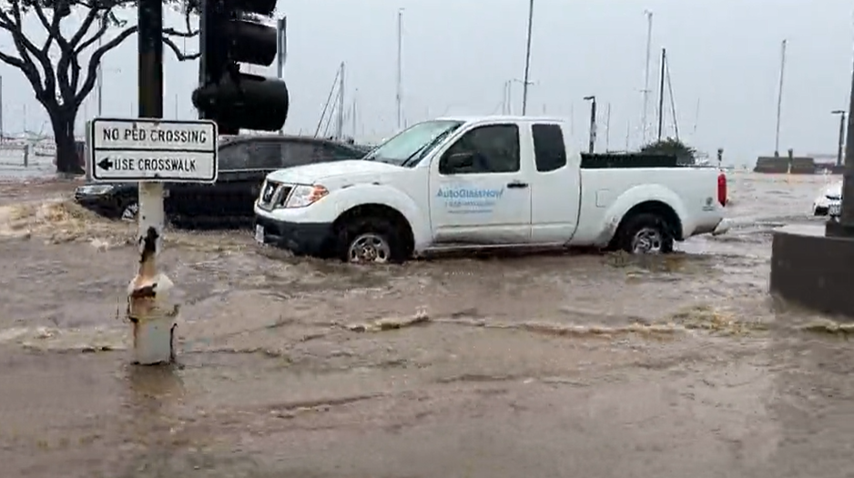 A truck drives through flooding on Harbor Drive near Laurel Street in downtown San Diego, Jan. 22, 2024.