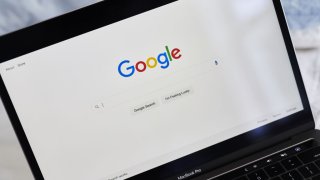 Google search page is displayed on a laptop computer.