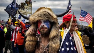 WASHINGTON, DC - JANUARY 6: Jacob Anthony Angeli Chansley, known as the QAnon Shaman, is seen at the Capital riots. On January 9, Chansley was arrested on federal charges of "knowingly entering or remaining in any restricted building or grounds without lawful authority, and with violent entry and disorderly conduct on Capitol grounds"Trump supporters clashed with police and security forces as people try to storm the US Capitol on January 6, 2021 in Washington, DC. Demonstrators breeched security and entered the Capitol as Congress debated the 2020 presidential election Electoral Vote Certification.