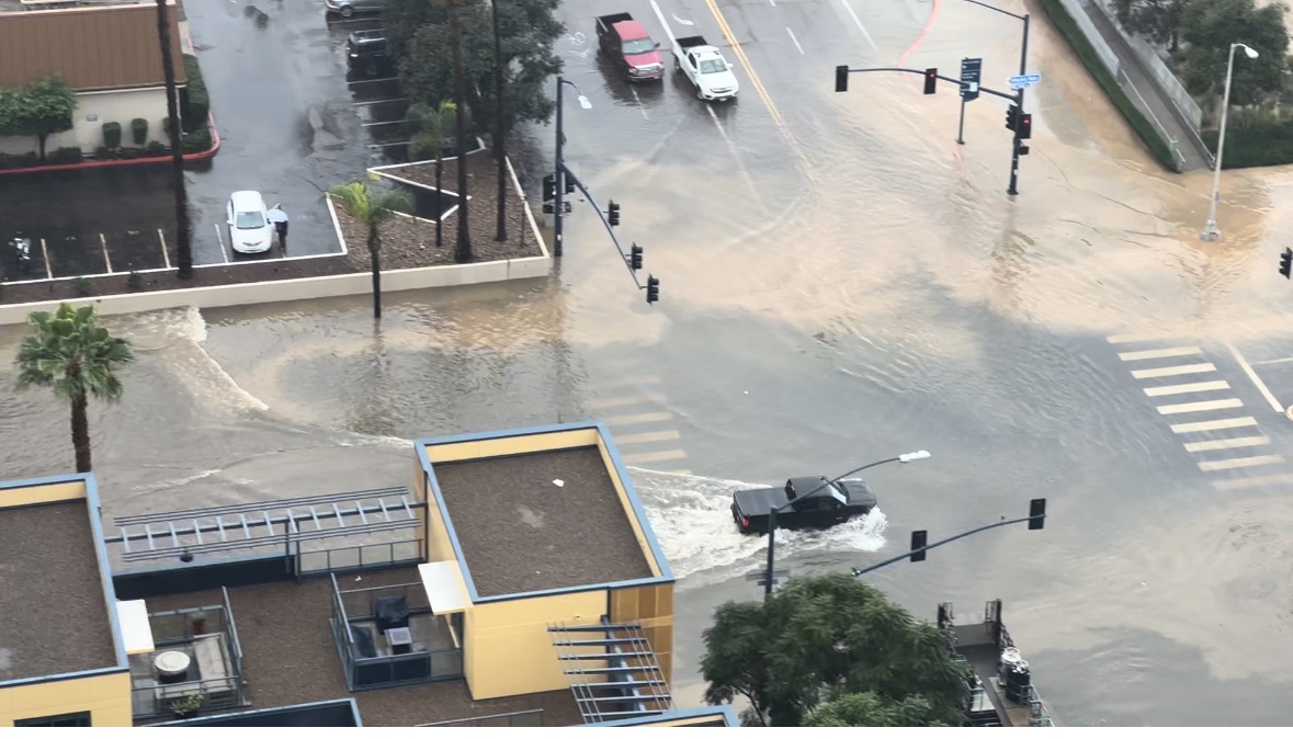 A truck drives through a flooded intersection in Little Italy, Jan. 22, 2024.