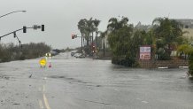 A flooding sign sits at the intersection of Valley Road and Carmel Valley Road in Sorrento Valley, San Diego, Jan. 22, 2024.