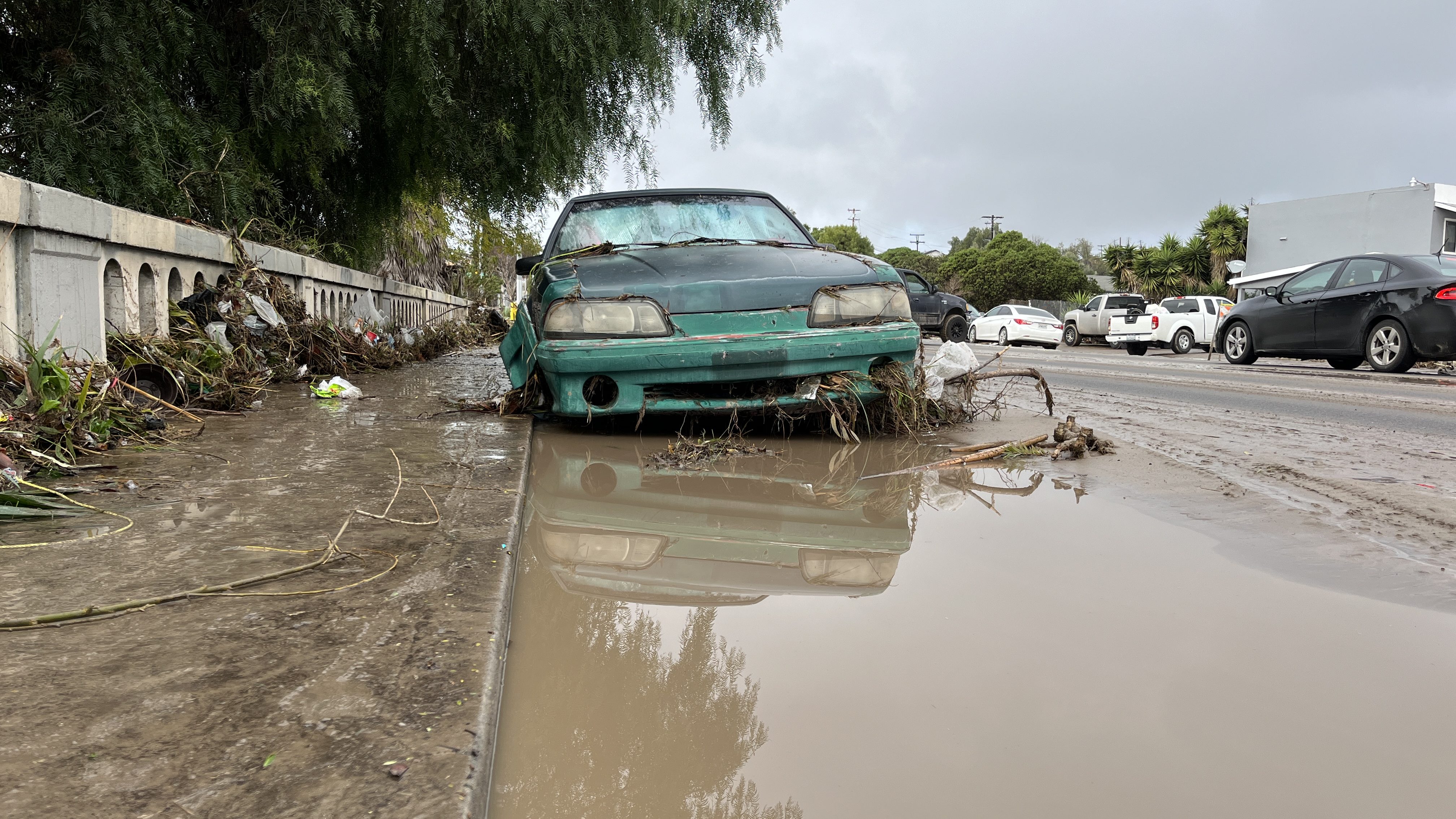 A car sits in floodwaters in San Diego’s Southcrest neighborhood the day after a powerful storm system on Jan. 23, 2024.