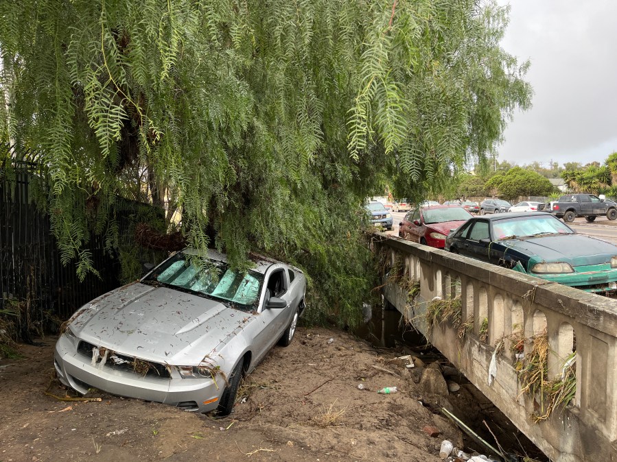 A car sits in floodwaters in San Diego's Southcrest neighborhood the day after a powerful storm system on Jan. 22, 2024.
