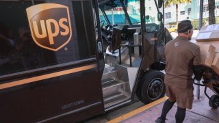 A UPS driver makes a delivery on January 30, 2024 in Miami Beach, Florida. 