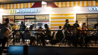 People dit at McDonald’s outdoor seating after going out on a Saturday night along Rothschild Street on June 11, 2022 in Tel Aviv, Israel. 