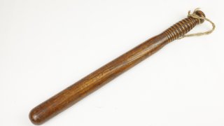 A wooden truncheon of the kind issued to police officers in the mid-20th century.
