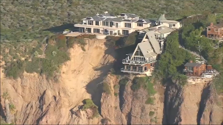 Video from KNBC shows three multi-million dollar homes teetering on the edge of a cliff in Dana Point after a landslide.