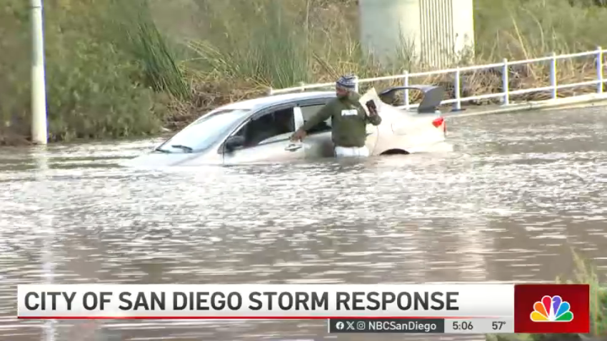 Man casually exits car after driving into flooded area of San Diego on live TV
