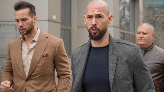 Andrew Tate, right, and his brother Tristan leave the tribunal in Bucharest, Romania.