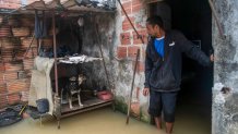 Nicelio Goncalves stands in his flooded home after heavy rains in Duque de Caxias, Brazil, Sunday, March 24, 2024. (AP Photo/Bruna Prado)