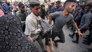 Palestinians carry a wounded person following an Israeli airstrike near the Al Aqsa hospital in Deir al Balah, Gaza Strip, Sunday, March 31, 2024. (AP Photo/Abdel Kareem Hana)