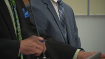 SDPD Officer Seth Tate (right), appears in court alongside a public defender.