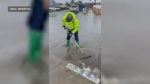 Greg Montoya helping clear the storm drain at the corner of Beta Street on Saturday, March 30, 2024.