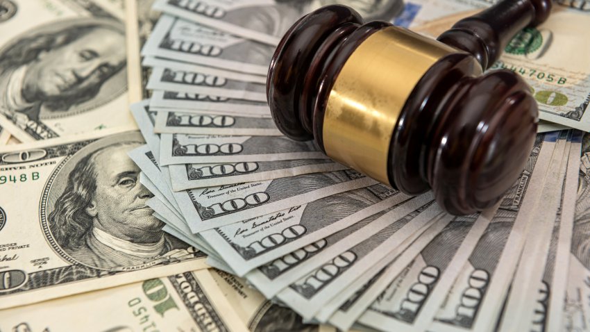Wooden judge gavel and us money dollar bills. Bribe concept