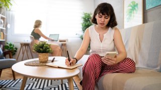 Worried woman looking at her mobile phone.