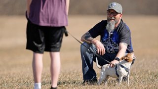 Dusty Farr talks with his transgender daughter at a park near Smithville, Mo., Sunday, Feb. 25, 2024.