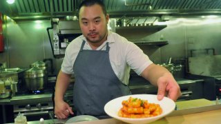 FILE - David Chang presents a dish at Momofuku Noodle Bar in New York on Thursday, Nov. 10, 2011. On Friday, April 12, 2024, Momofuku, a food and restaurant brand started by food mogul Chang, said it won't defend its trademark on the name “chile crunch” after it sparked an outcry by sending cease-and-desist letters to other businesses using the term. (AP Photo/Diane Bondareff, File)