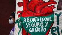 FILE - A woman holds a banner reading in Spanish, "Legal, safe, and free abortion" as abortion rights protesters demonstrate in front of the National Congress on the "Day for Decriminalization of Abortion in Latin America and the Caribbean," in Mexico City, Sept. 28, 2020. Mexico’s Supreme Court ruled in 2023 that national laws prohibiting abortions are unconstitutional and violate women’s rights.  (AP Photo/Rebecca Blackwell, File)