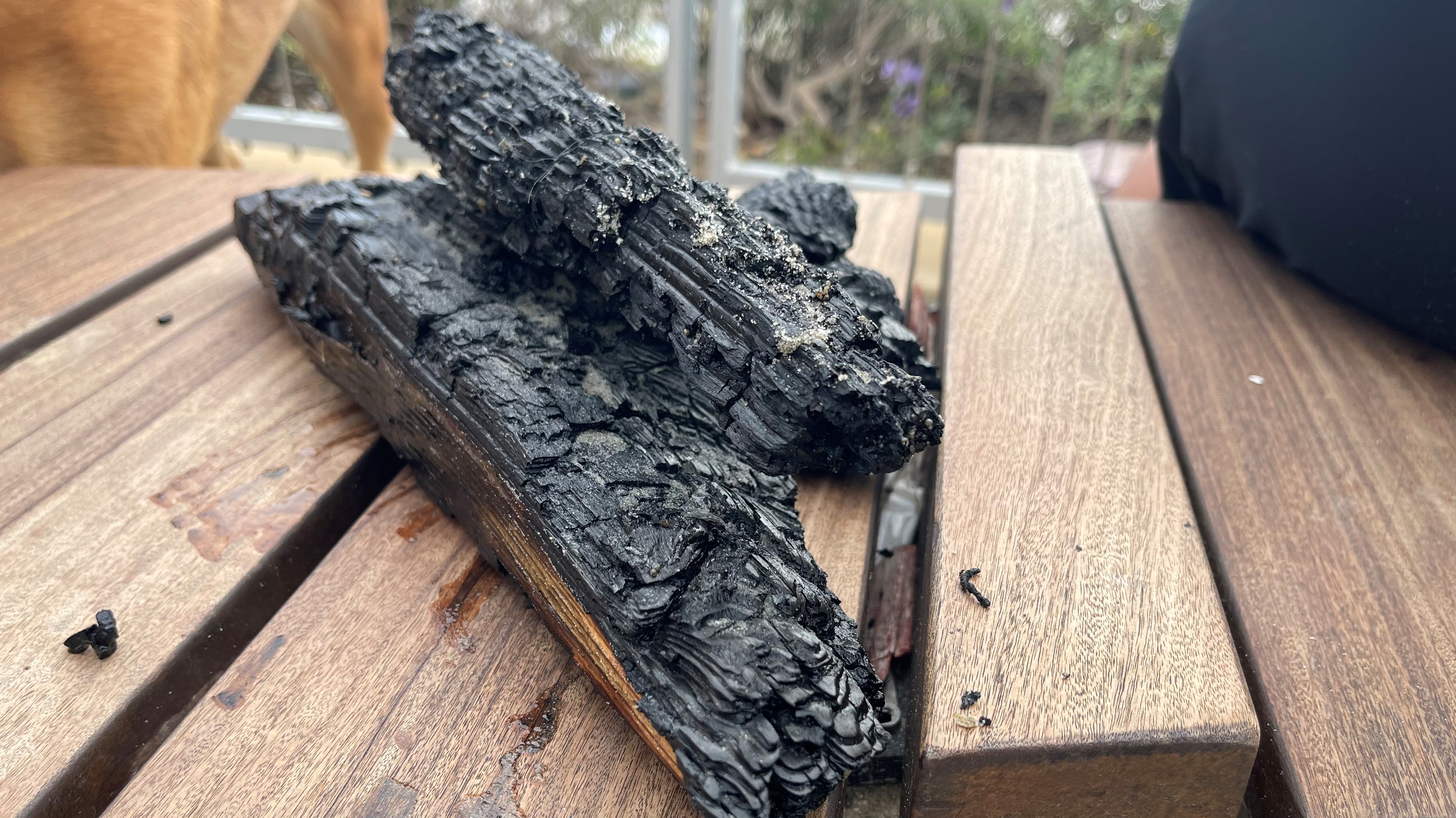 Pieces of charred pier washing ashore