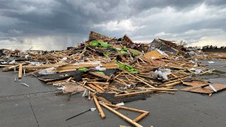 Debris is seen from a destroyed home northwest of Omaha, Neb., after a storm tore through the area on April 26, 2024.