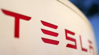 FILE – The logo for the Tesla Supercharger station is seen in Buford, Ga, April 22, 2021.