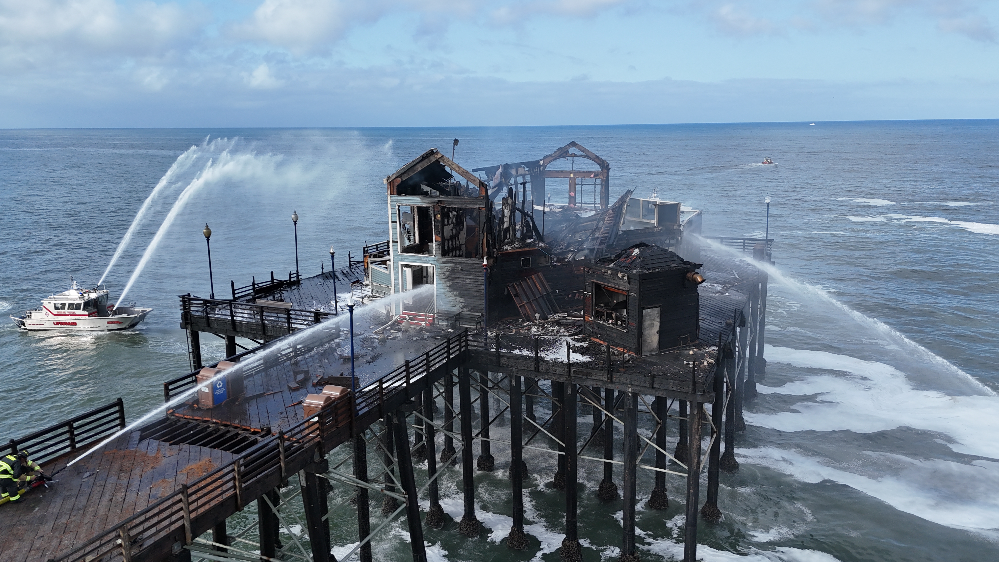 Flames continued to burn on the Oceanside Pier from the day before on April 26, 2024. (Hunter Cochran)