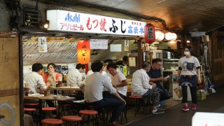 People enjoy food and drink at an izakaya bar near Yurakucho Station on June 05, 2020 in Tokyo, Japan.