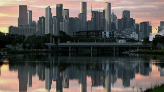 The Melbourne skyline is reflected in the Maribyrnong River in the early morning light on April 18, 2023.