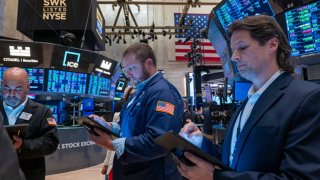 Traders work on the floor during morning trading at the New York Stock Exchange on May 14, 2024.