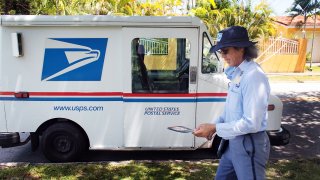 MIAMI - AUGUST 05: U.S. Postal Service mail carrier, Alberto Jo, delivers mail to homes on August 5, 2010 in Miami, Florida. (Photo by Joe Raedle/Getty Images)