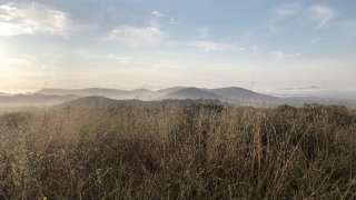 Photo taken from Double Peak in San Marcos, California shows dry brush on the mountainside.