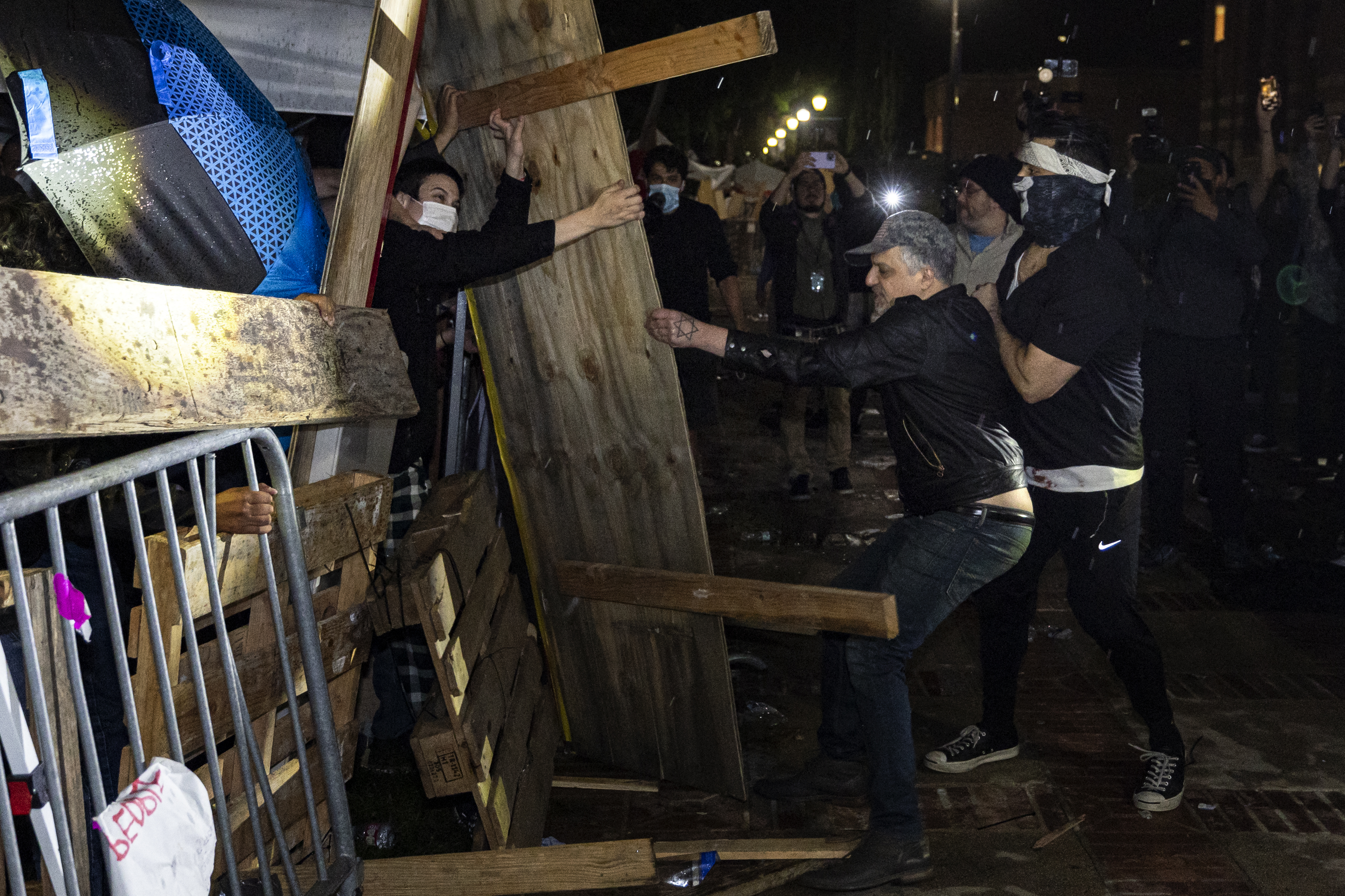 Counter-protesters attack a pro-Palestinian encampment set up on the UCLA campus on May 1, 2024.