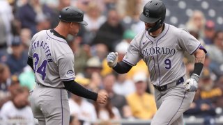 SAN DIEGO, CALIFORNIA – MAY 15: Third base coach Warren Schaeffer #34 of the Colorado Rockies congratulates Brenton Doyle #9 of the Colorado Rockies after his solo homerun during the second inning of a game against the San Diego Padres at Petco Park on May 15, 2024 in San Diego, California. (Photo by Sean M. Haffey/Getty Images)