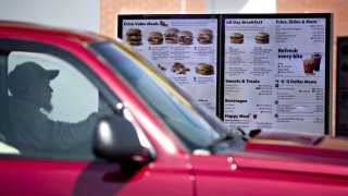 A customer views a digital menu at the drive-thru outside a McDonald’s restaurant in Peru, Illinois.