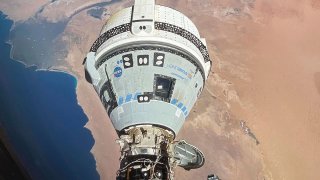 This photo provided by NASA shows the Starliner spacecraft docked to the Harmony module of the International Space Station, orbiting 262 miles above Egypt's Mediterranean coast, on June 13, 2024.