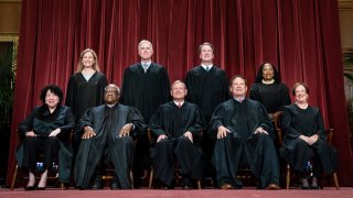 Members of the Supreme Court sit for a group photo.