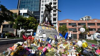 SAN DIEGO, CA – JUNE 18: Fans of the late Tony Gwynn #19 of the San Diego Padres pay tribute to him at his commemorative statue at Petco Park before a baseball game between the San Diego Padres and the Seattle Mariners June 18, 2014 in San Diego, California. Gwynn, the former Padres’ outfielder and ML Baseball Hall of Famer passed away at age 54 earlier in the week. (Photo by Denis Poroy/Getty Images)