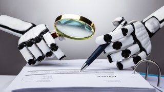 Photo Of Robot Examining Invoice With Magnifying Glass.