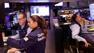 Traders work on the floor of the New York Stock exchange during morning trading on May 17, 2024.