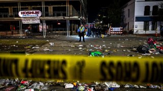 Police officers work at the scene of a shooting that occured during the Krewe of Bacchus parade in New Orleans, February 19, 2023. 