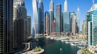 Aerial view of cityscape and skyscraper at sunset in Dubai Marina.